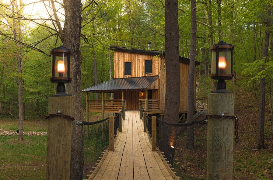 treehouse with a little bridge in the woods