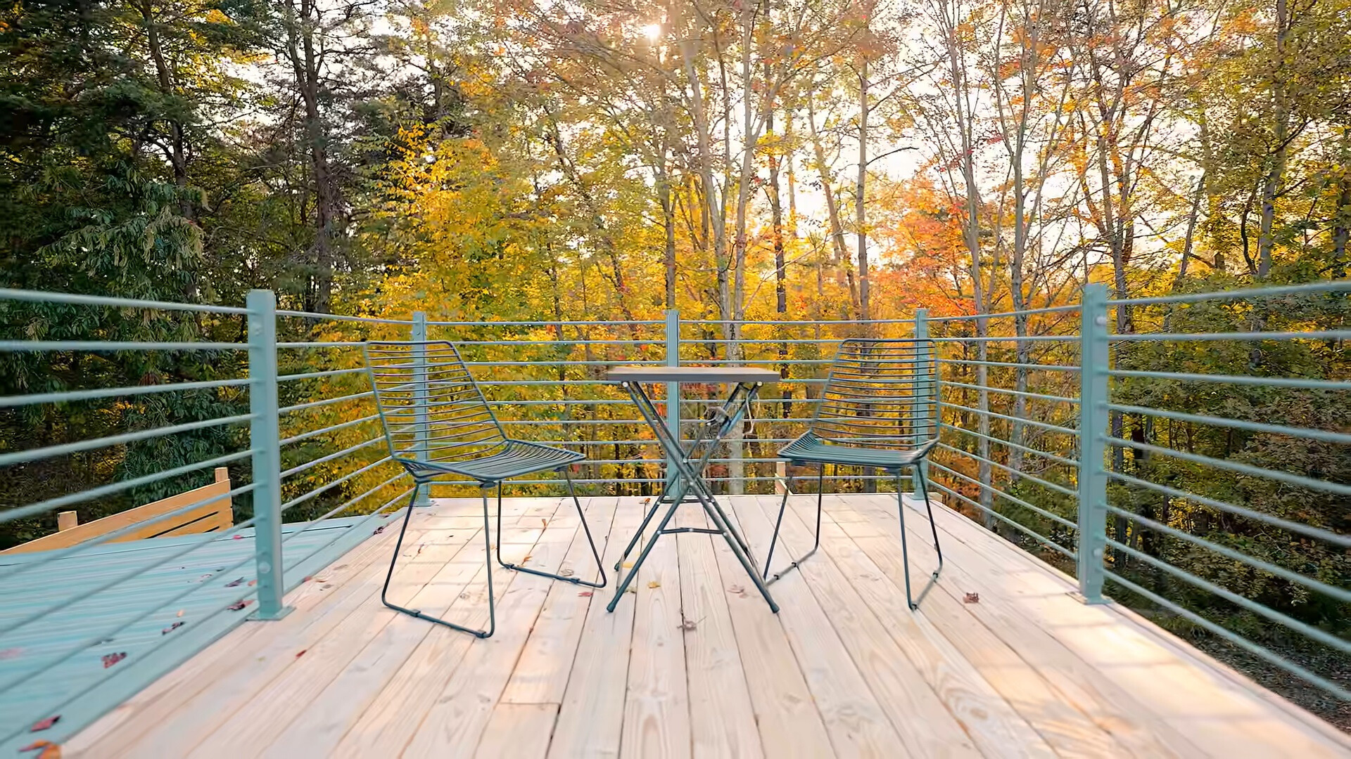 roof of the container house with two small chairs and a mini table