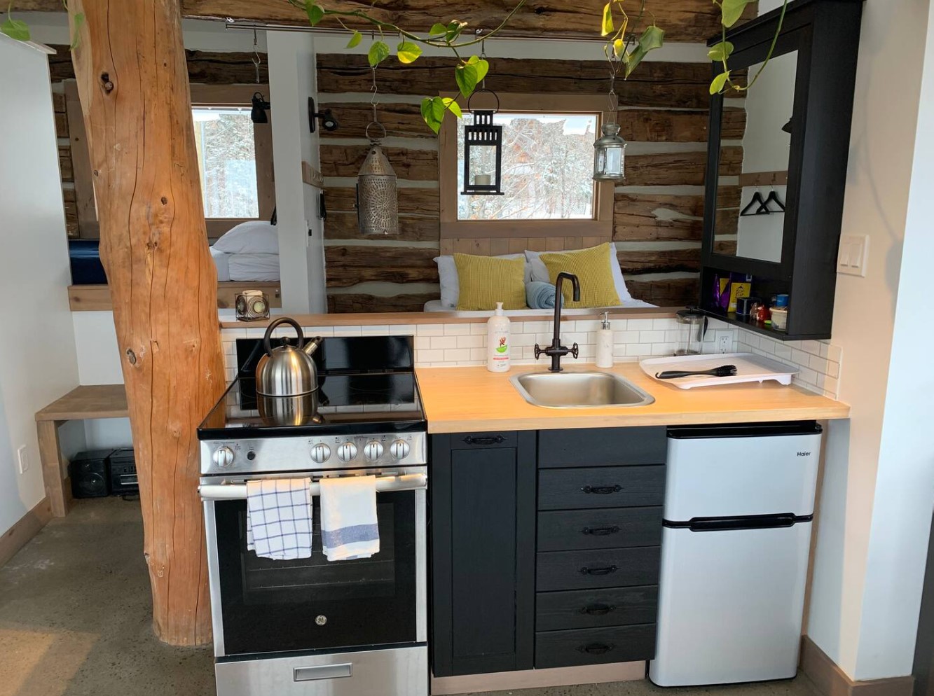 Small kitchen with full-sized stove and black cabinetry