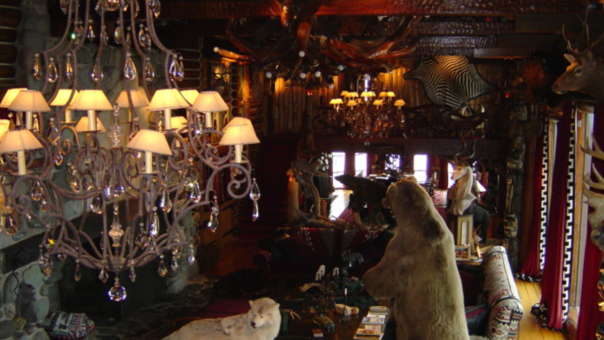 the great hall of the granot loma with chandeliers, dark and gloomy atmosphere, and taxidermy animals