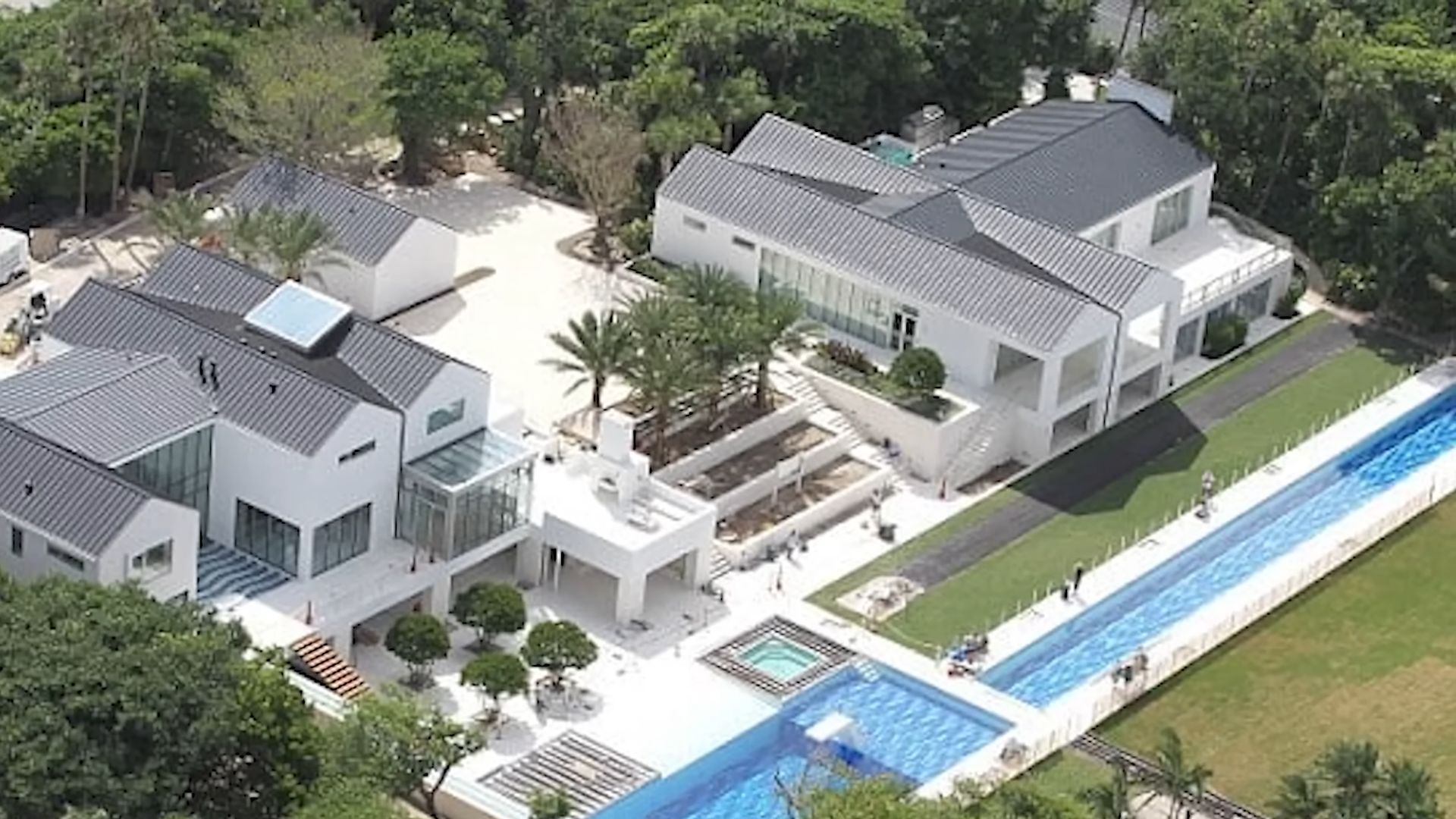 tiger woods mega-mansion with a big and narrow pool and a private golf course