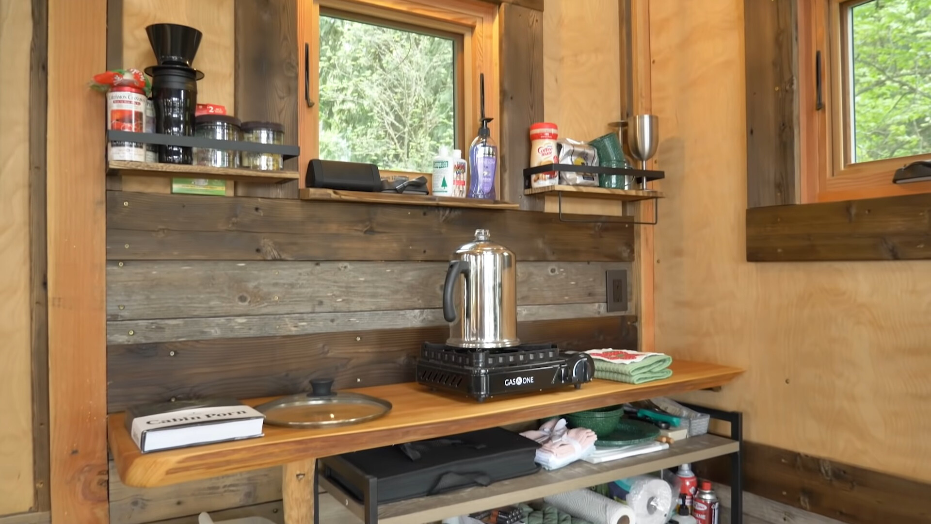 tiny kitchen with a wooden countertop and shelves with spices