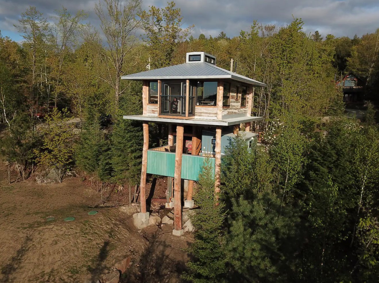 Two floor tree house in the middle of a forest