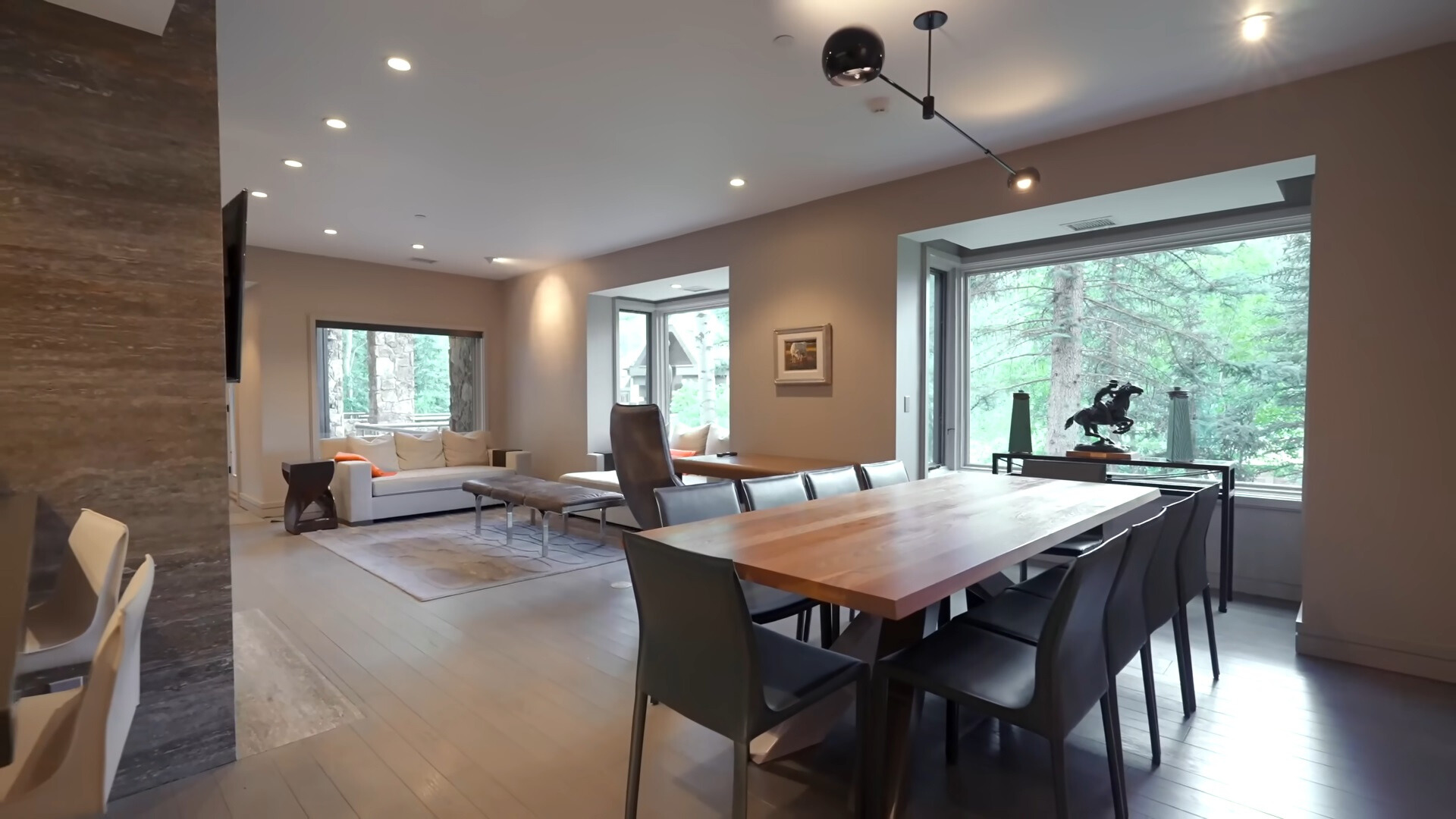 living area with a white couch and a dining area with a brown dining table and black chairs