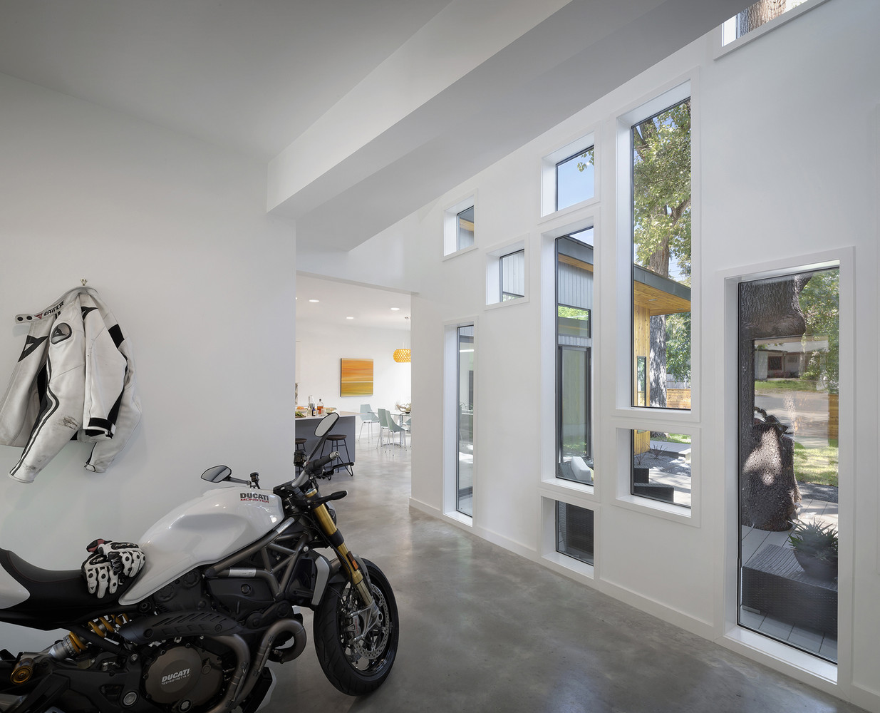 windows of different sizes in a hall with a motorbike parked inside