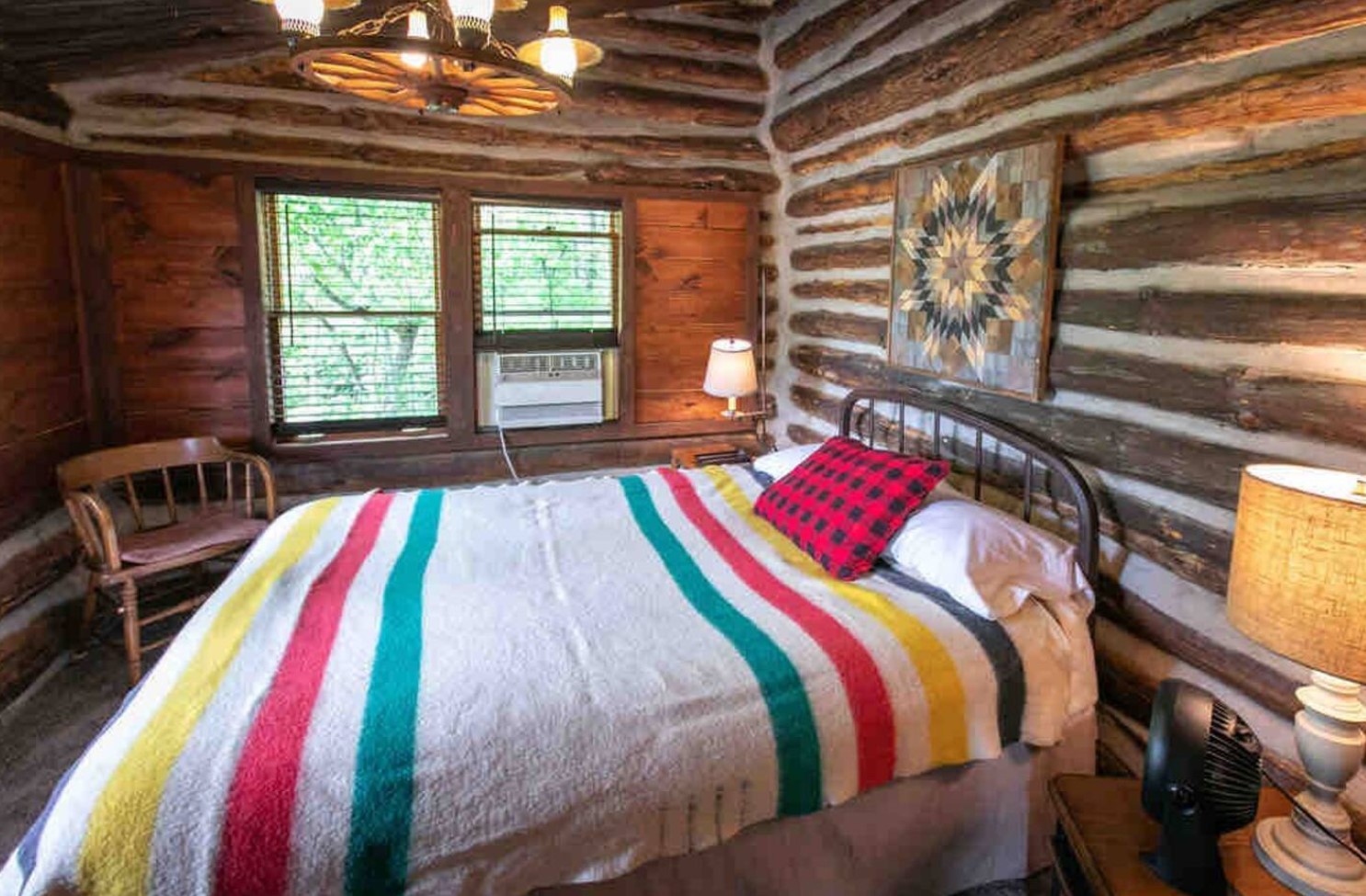 Bedroom with a full-sized bed and a colorful blanket