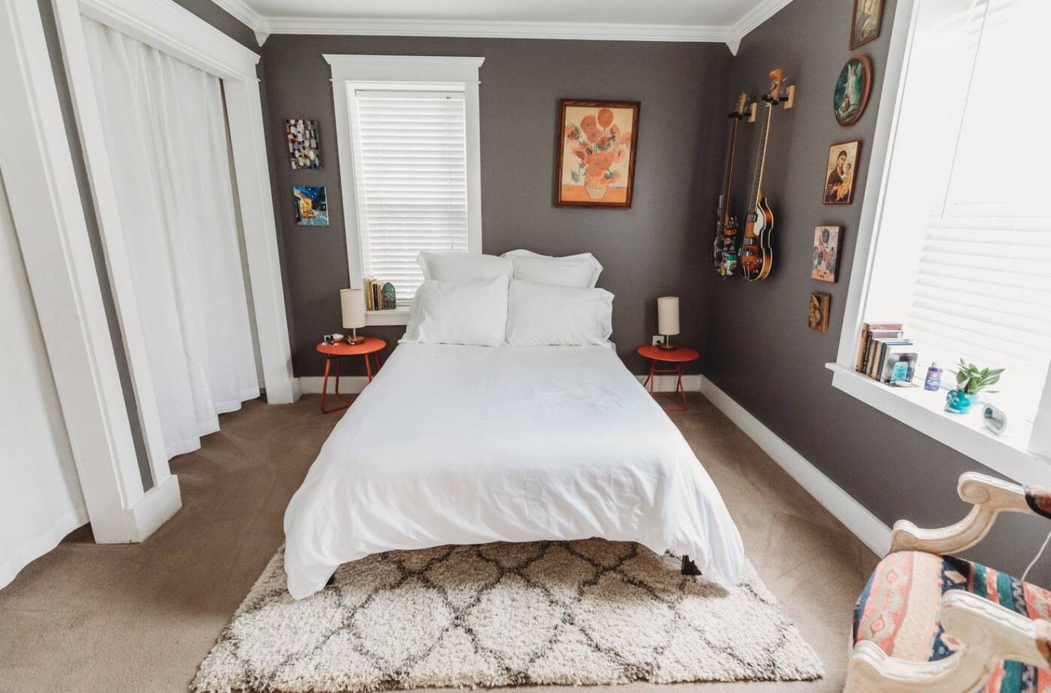 Bedroom with gray walls, red nightstands and decorations