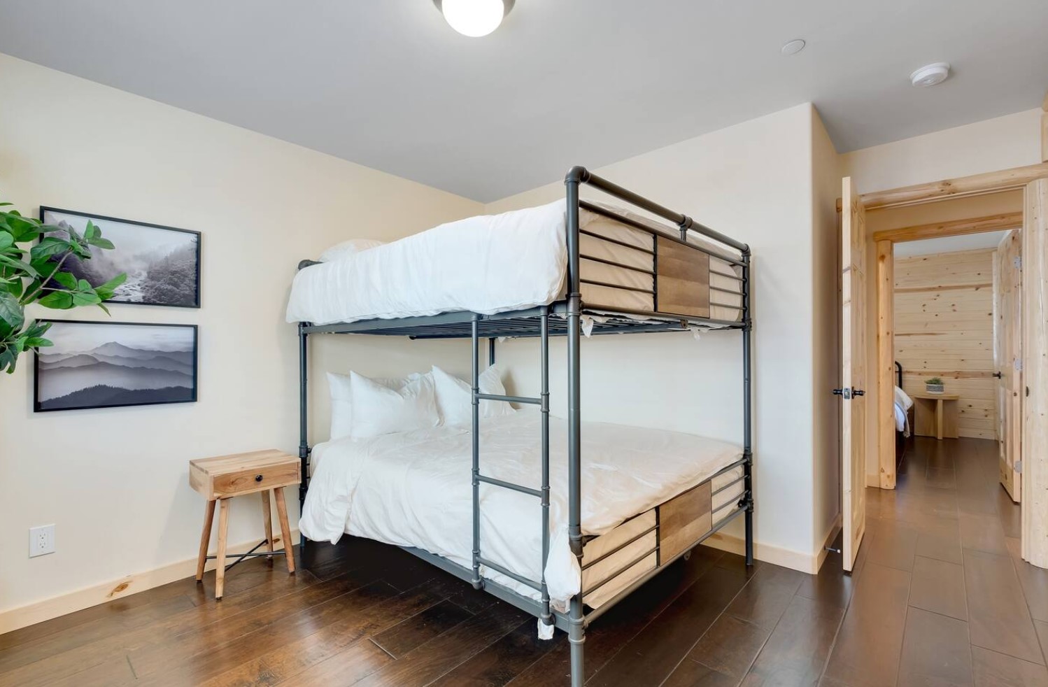 Bedroom with queen-sized bunkbeds and wooden nightstand