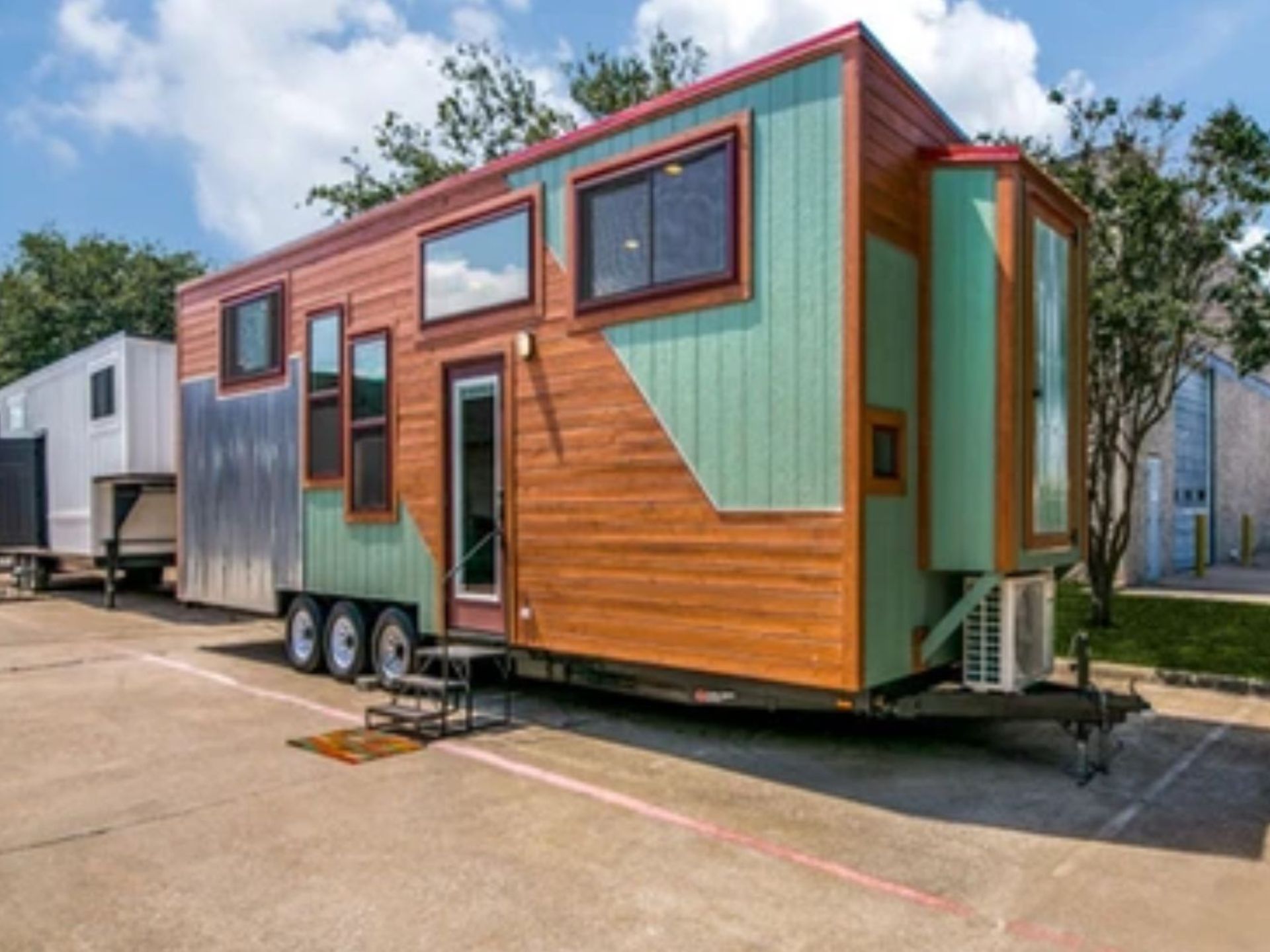 side view of the big bertha thow with blue and cedar siding and metal siding in the left corner