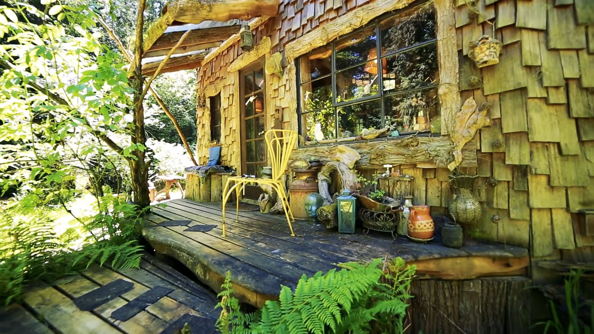 Wooden deck of a cabin with a window and decorations