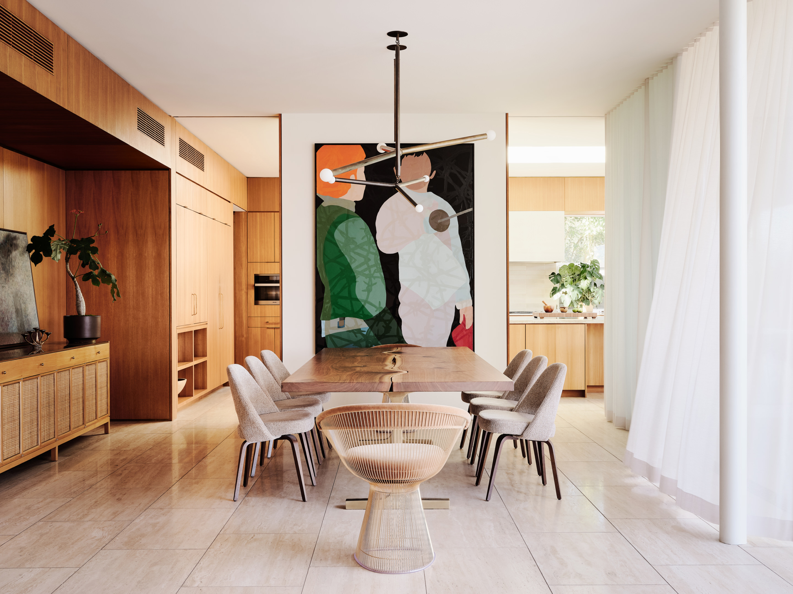 Dining area with a huge table and a piece of art