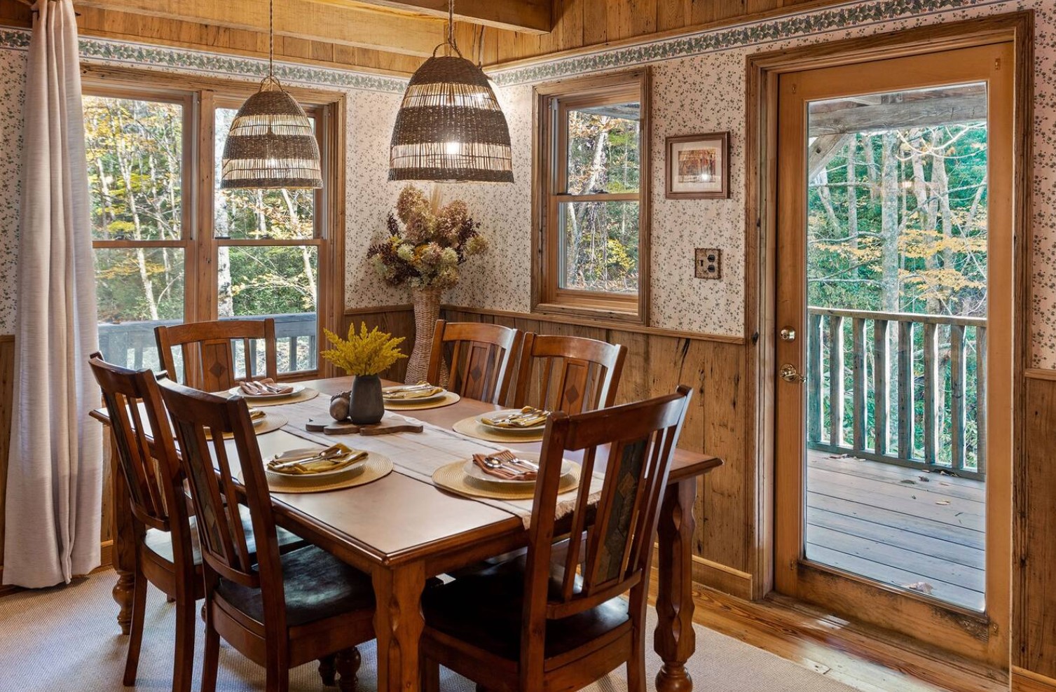 Adorable dining room with wallpaper and a balcony