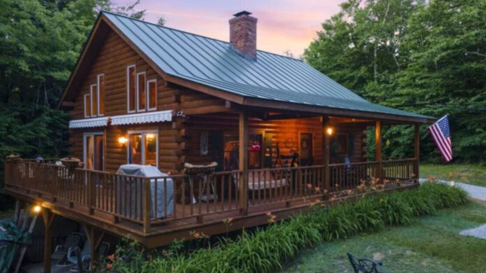 Brown log cabin with wrap-around porch