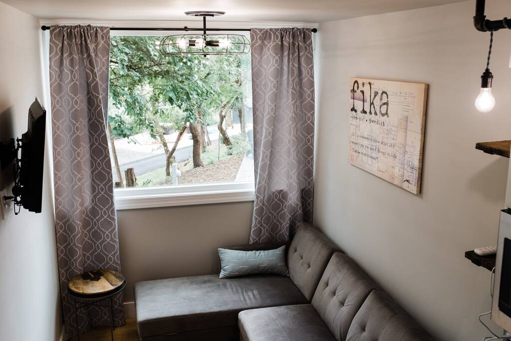 gray living room in container home with a huge window