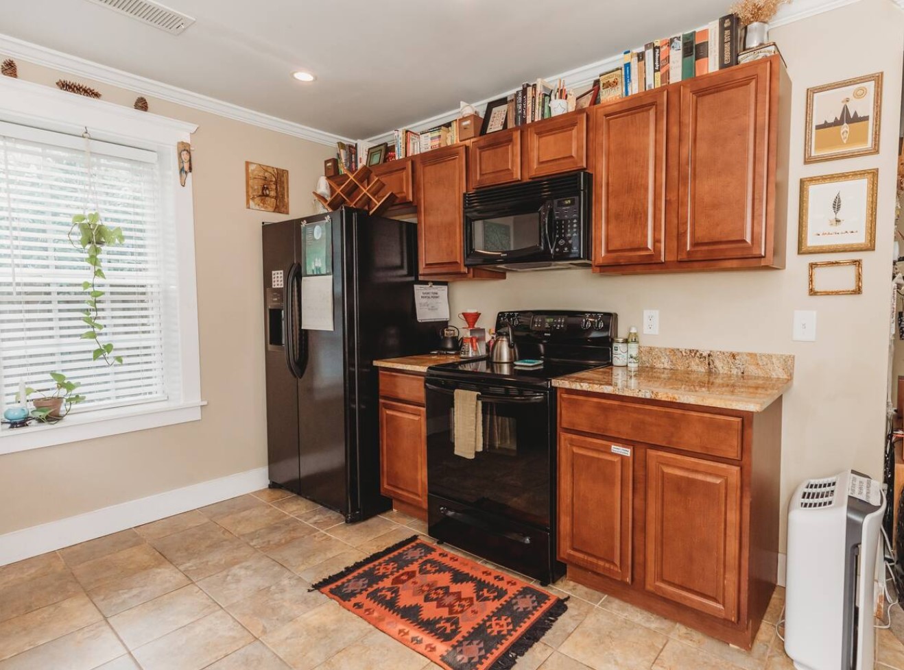 Kitchen with wooden cabinets and marble countertops