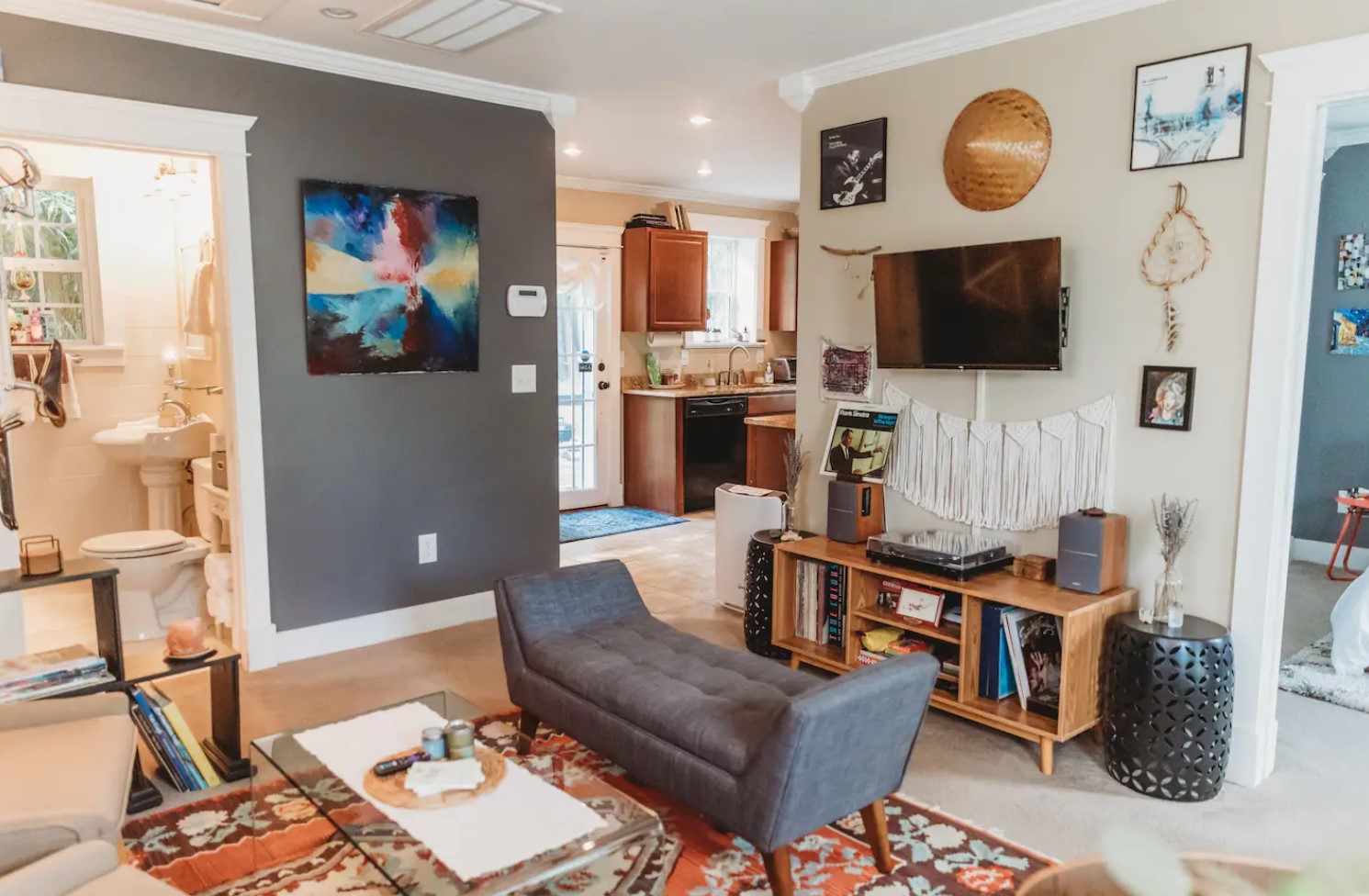 Living room with a gray sofa and colorful decorations