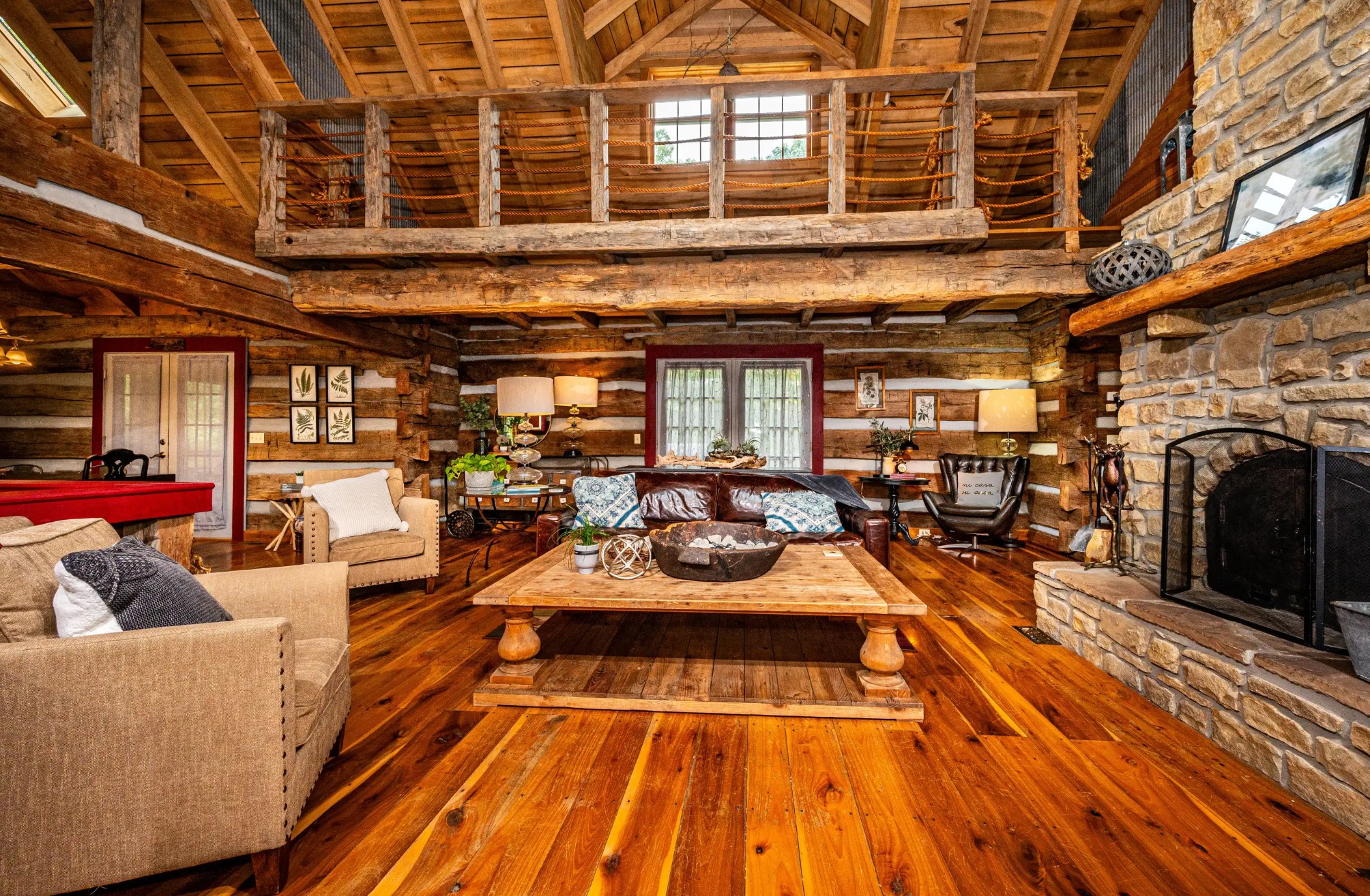 Living room with a huge coffee table and a stone fireplace