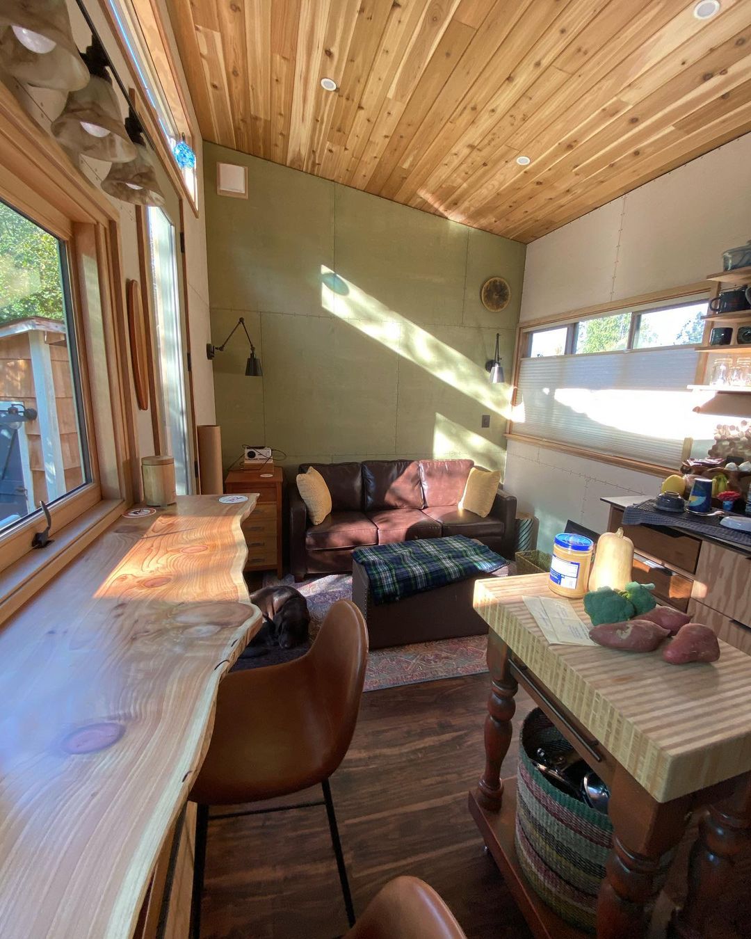 Living room with high ceilings and a leather couch