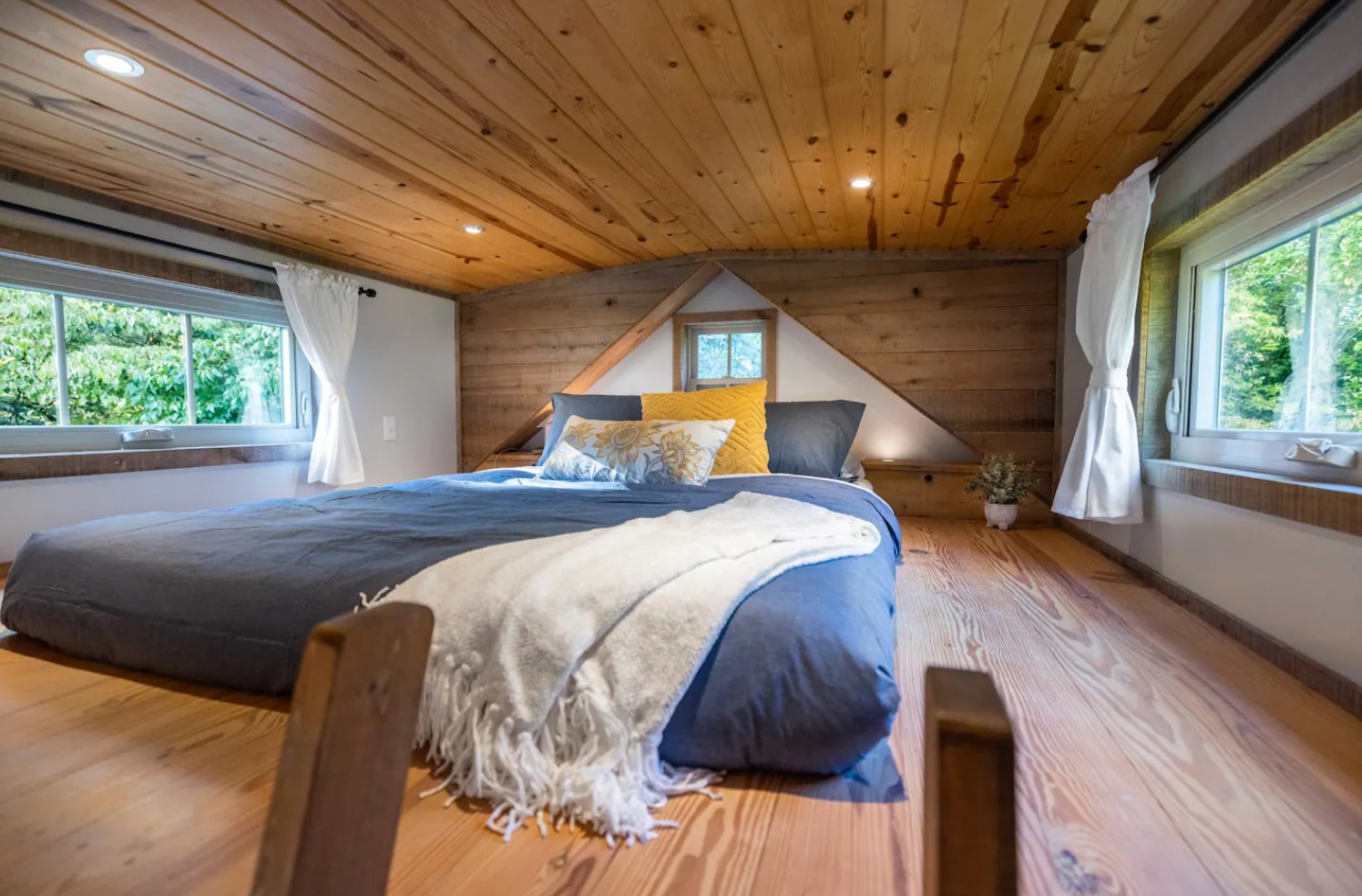 Loft with a queen-sized bed and two windows