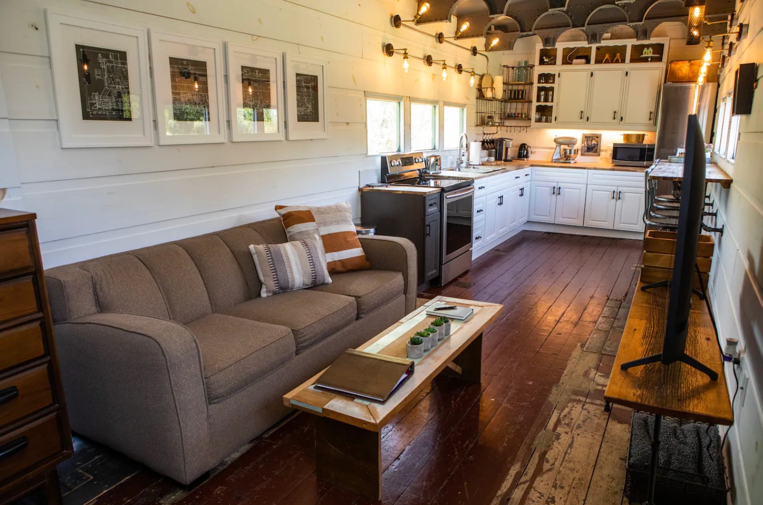 Rustic styled living room with brown couch and TV