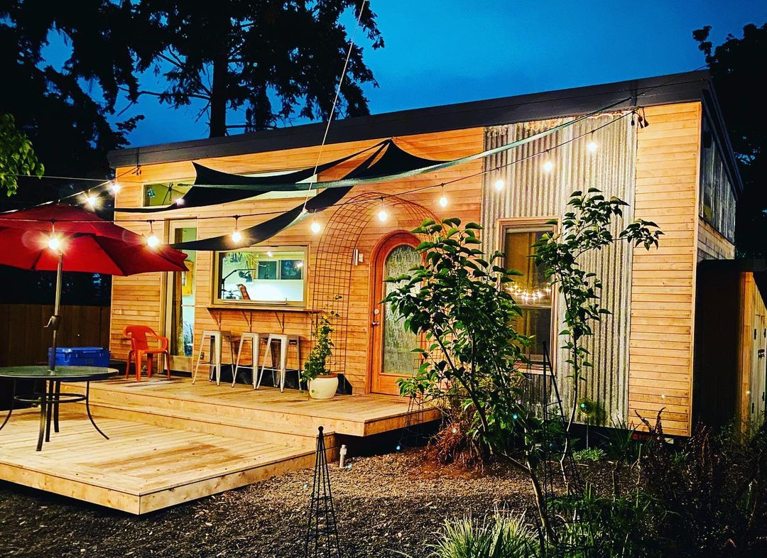 Tiny home with a front deck and fairy lights