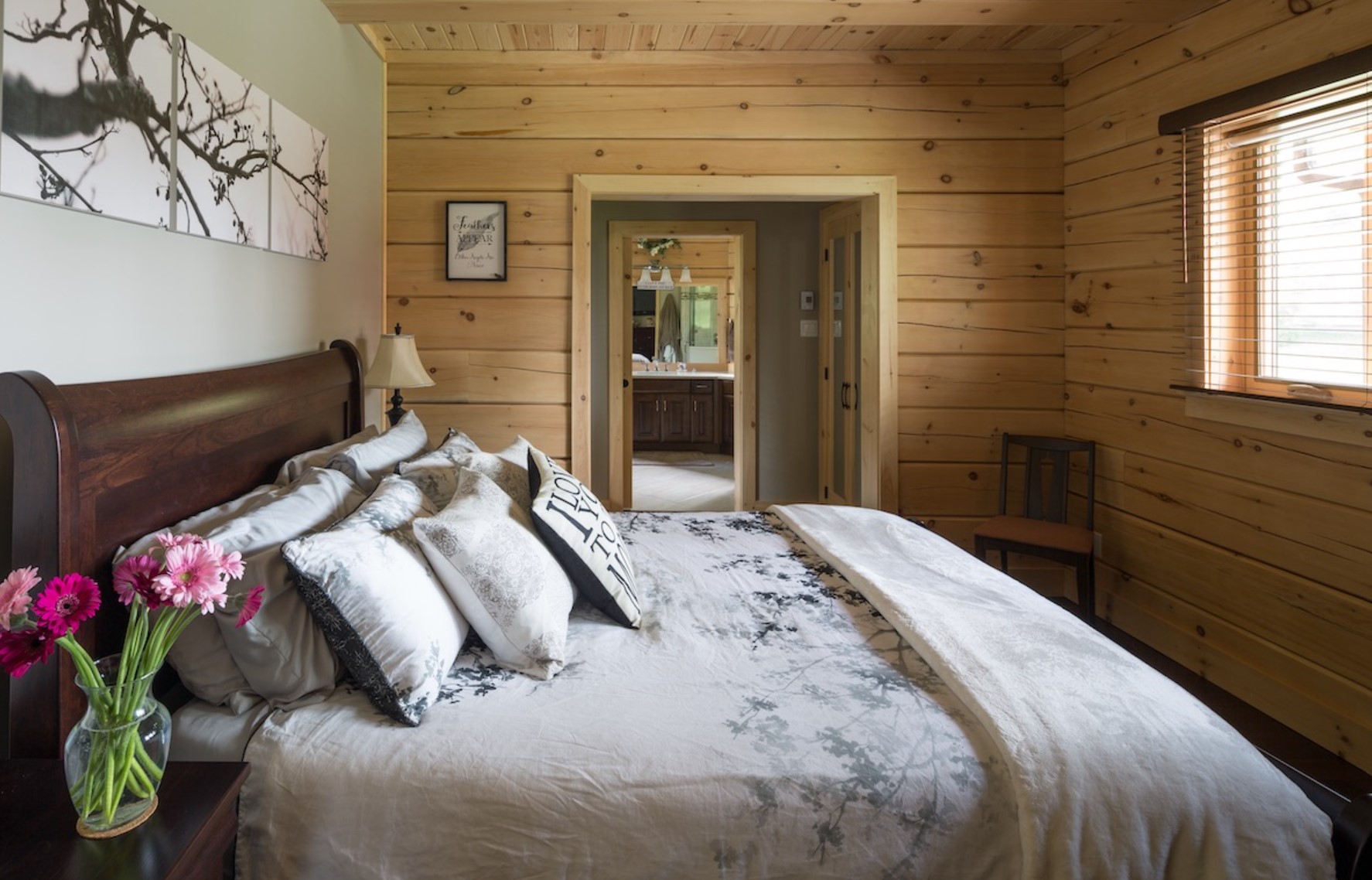 Wooden bedroom with queen-sized bed and beautiful decor