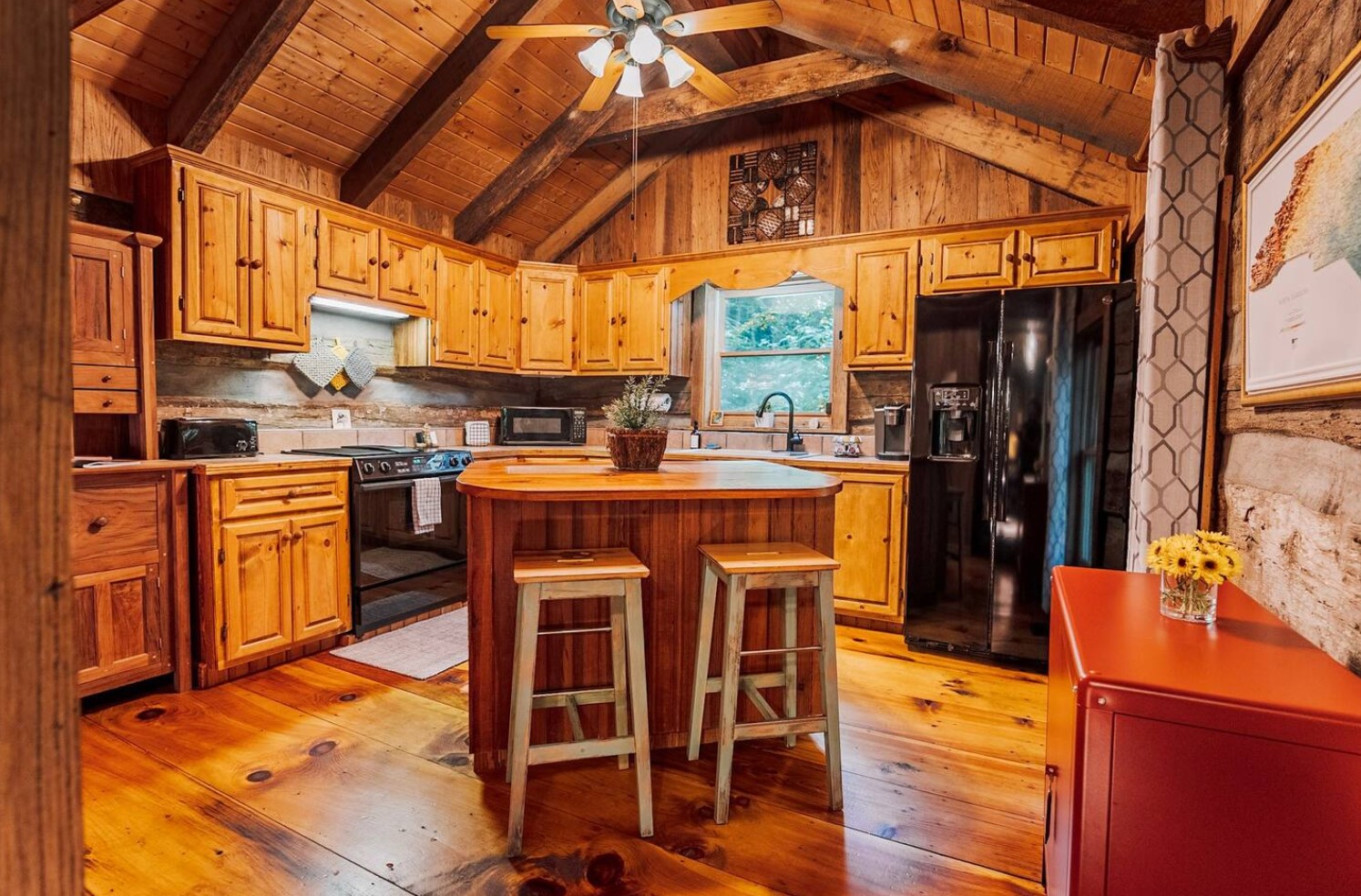 Spacious wooden kitchen with island and stools