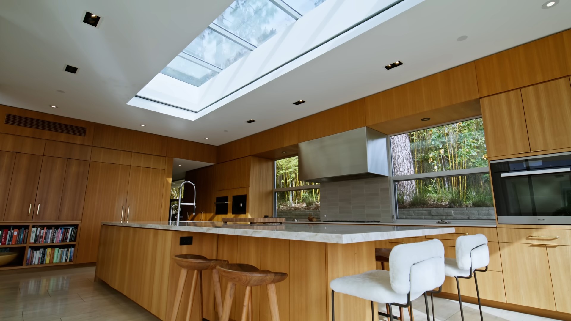 Wooden kitchen with a huge island and a sky light