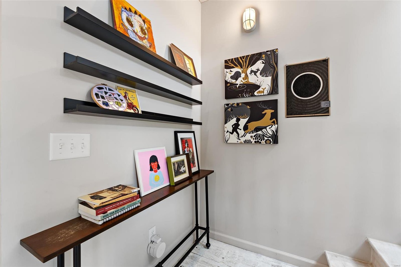 area with art pieces on the shelf and hung on the walls