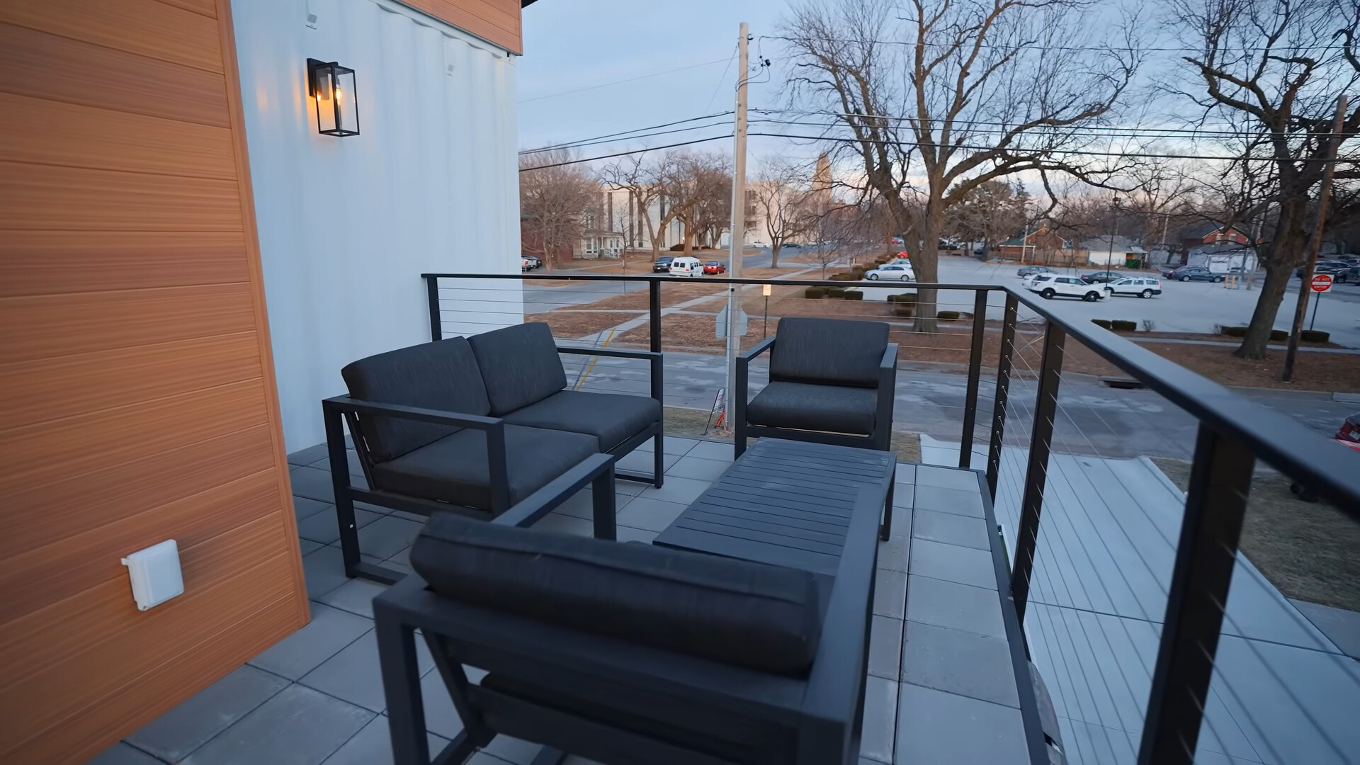 balcony with a cushioned sitting area and a black table