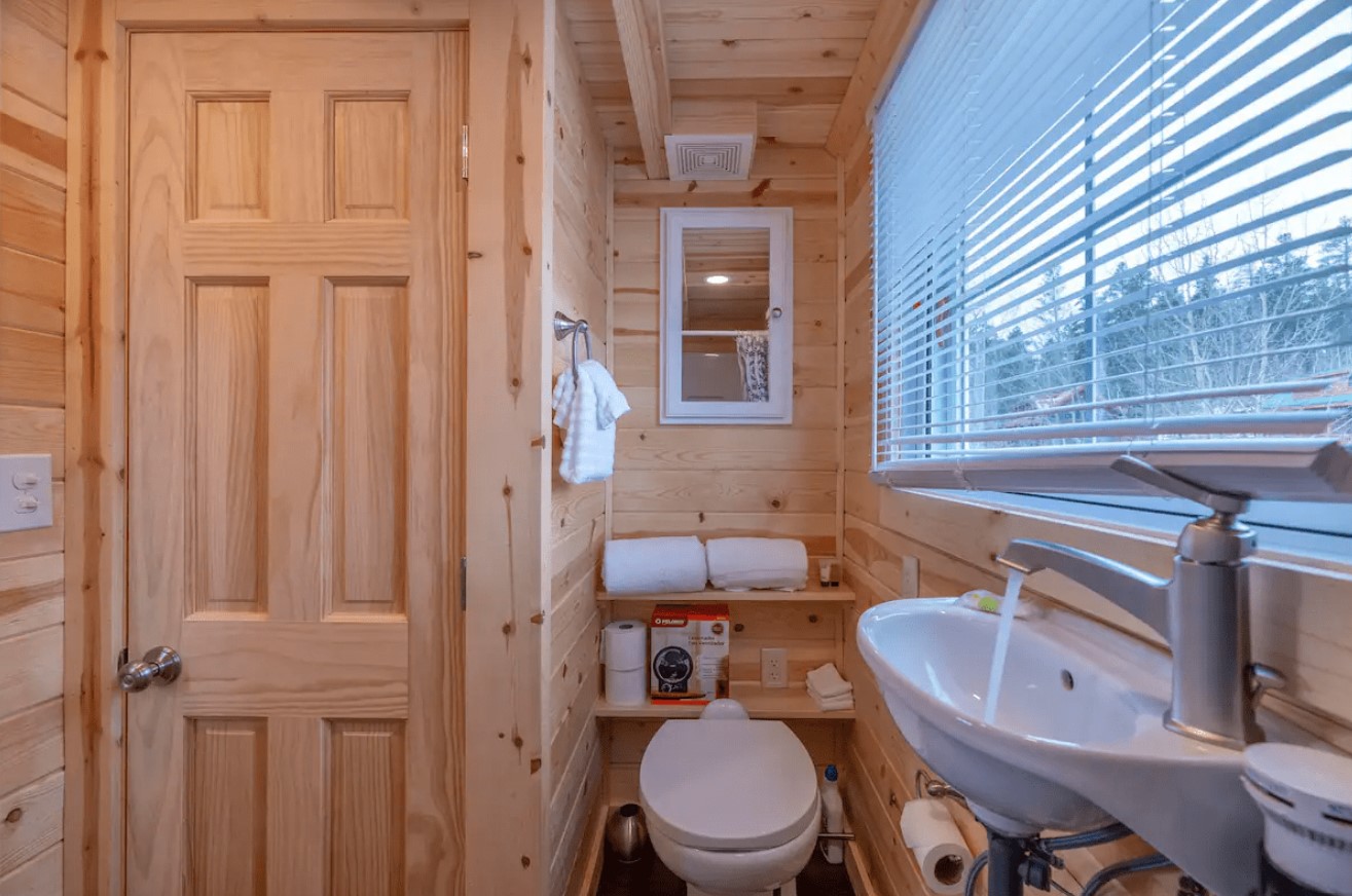 bathroom with a big window and wooden walls