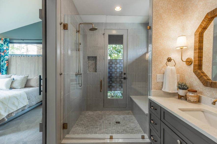 bathroom with a huge glass shower, dark gray cabinet and wooden mirror