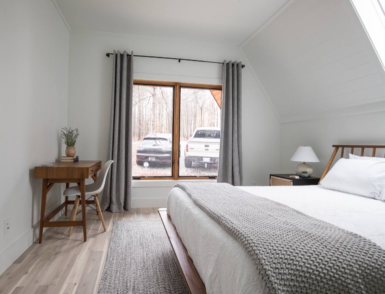 bedroom with a bed, a brown desk in the corner and a chair