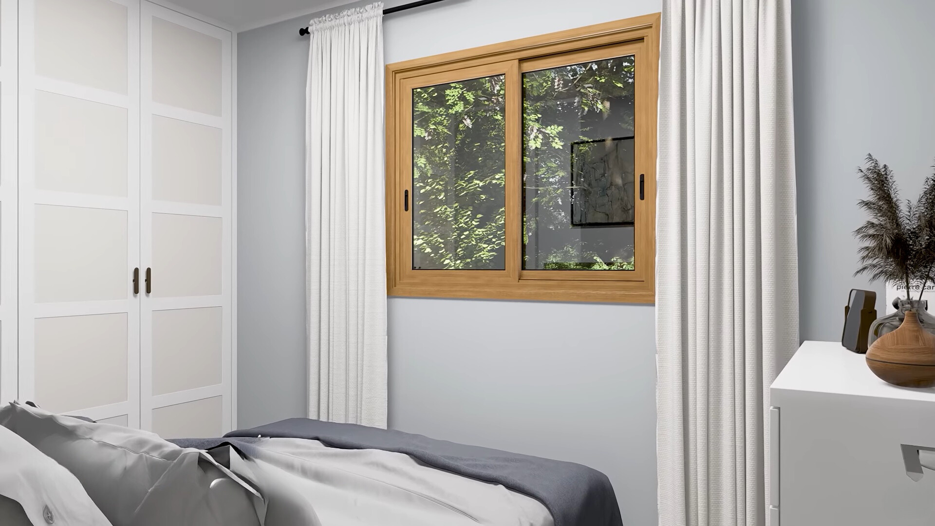 bedroom with a window opposite the bed and a white closet and cabinet