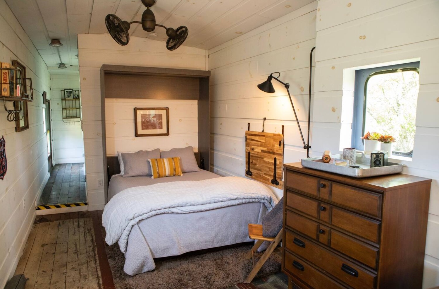 Bedroom with a Murphy bed and a wooden dresser