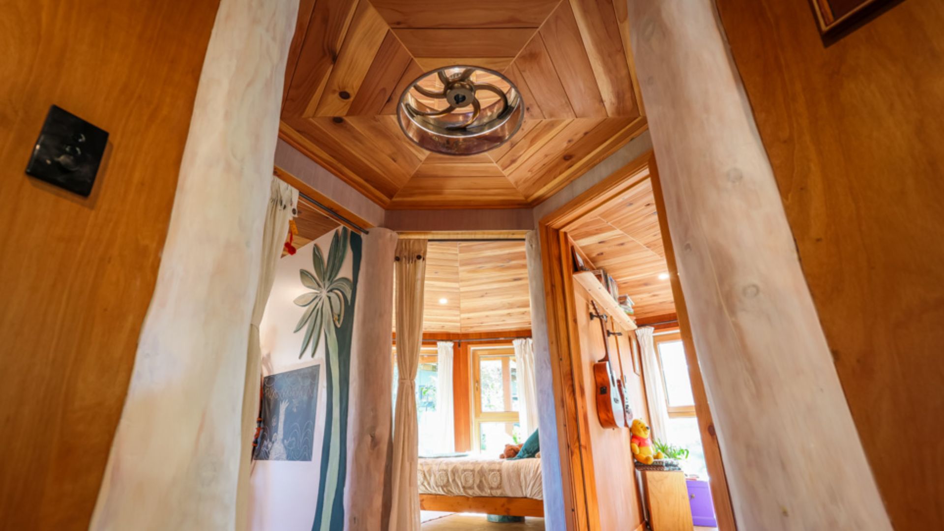 circular ceiling covered in wooden planks, ventilation in the middle of the round house