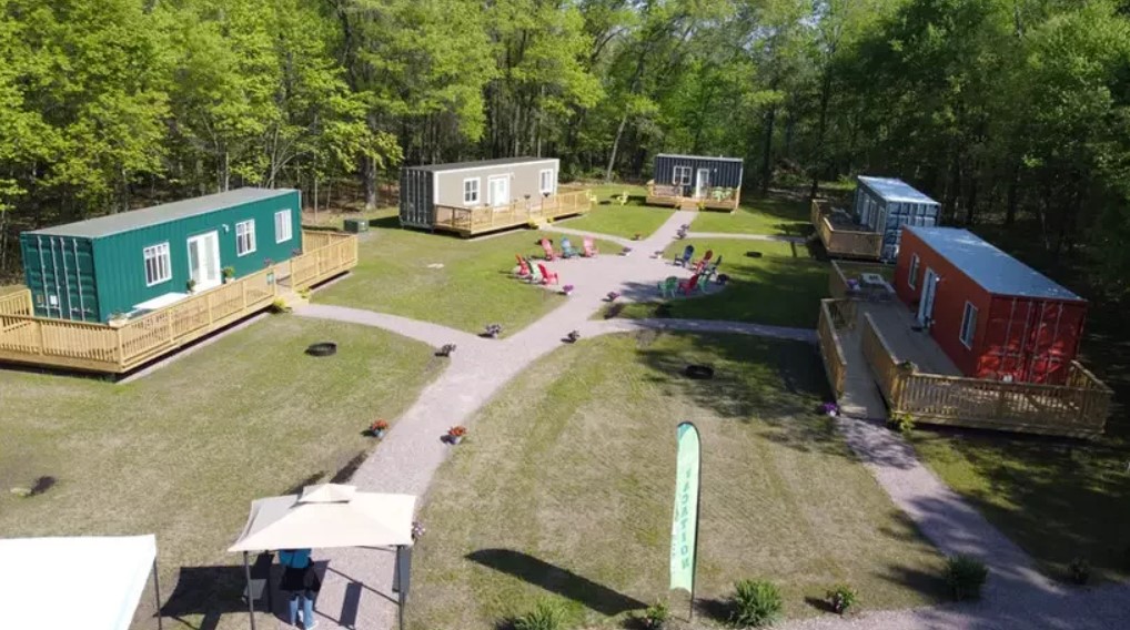 container village consisting of five containers surrounded by nature