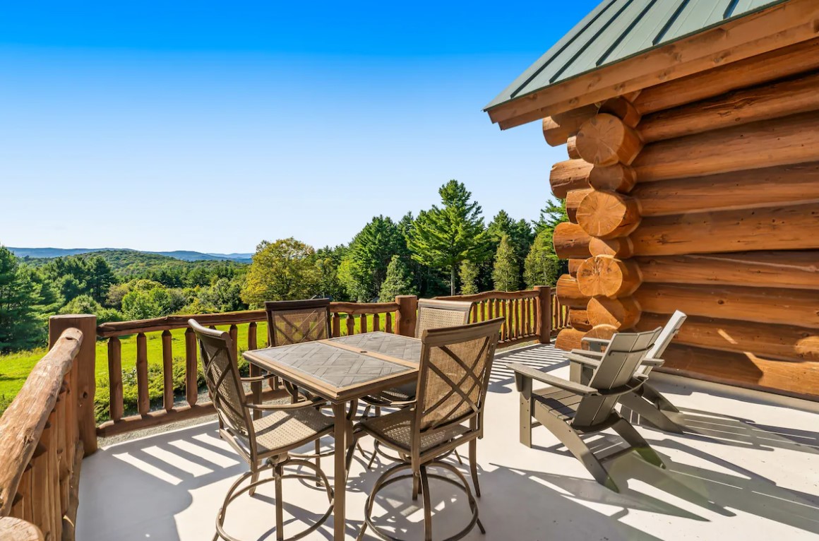 deck with green chairs and a table surrounded by chairs