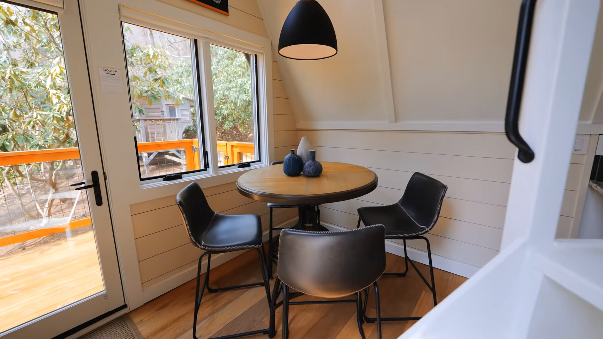 dining area with a round, brown table and black chairs