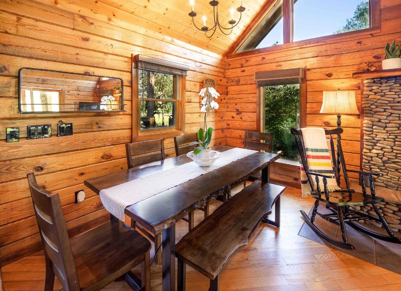 dining room with a long, brown dining table, brown bench and brown chairs