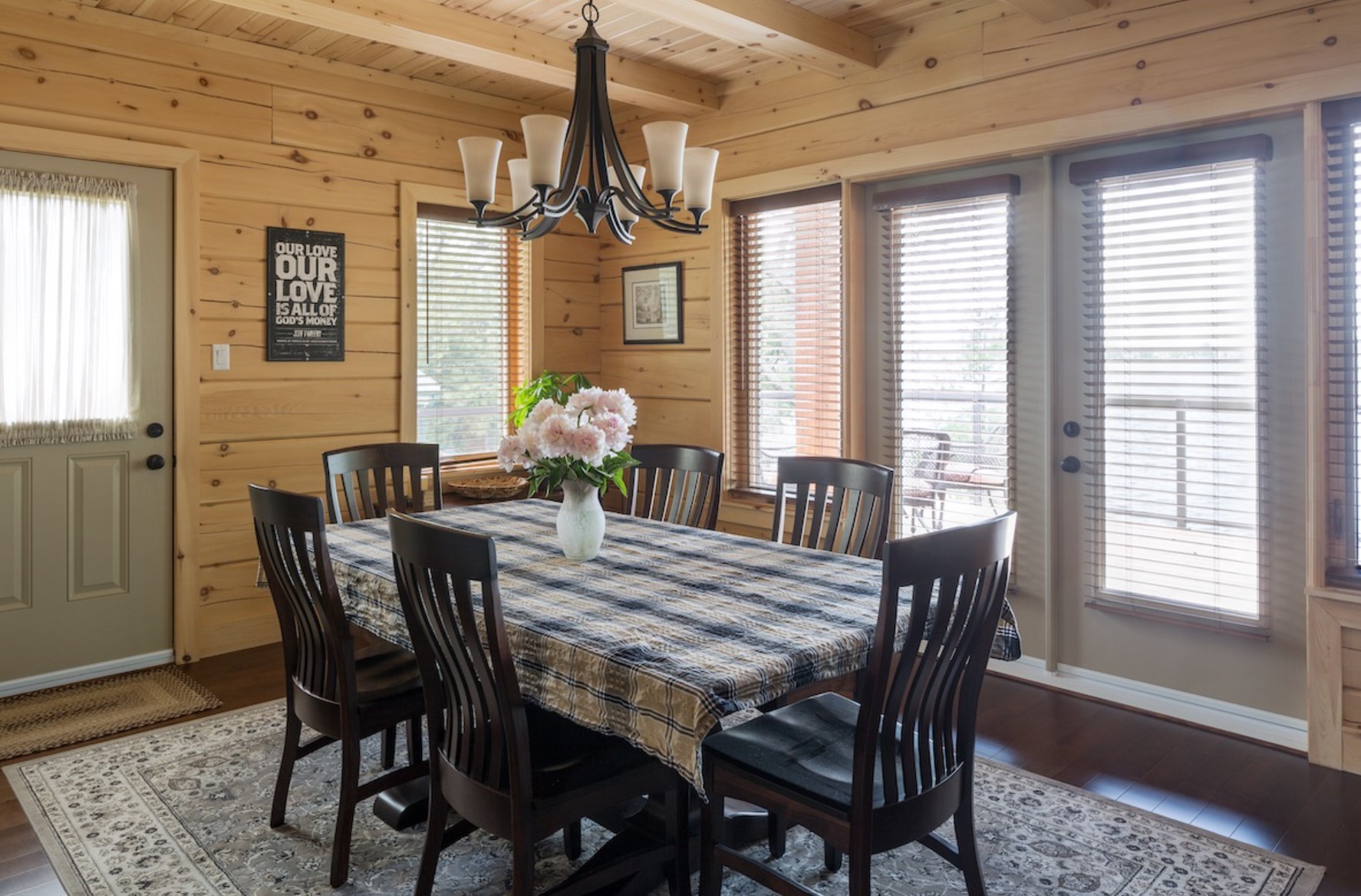 Dining room with darkly stained table and chairs and a stunning light fixture