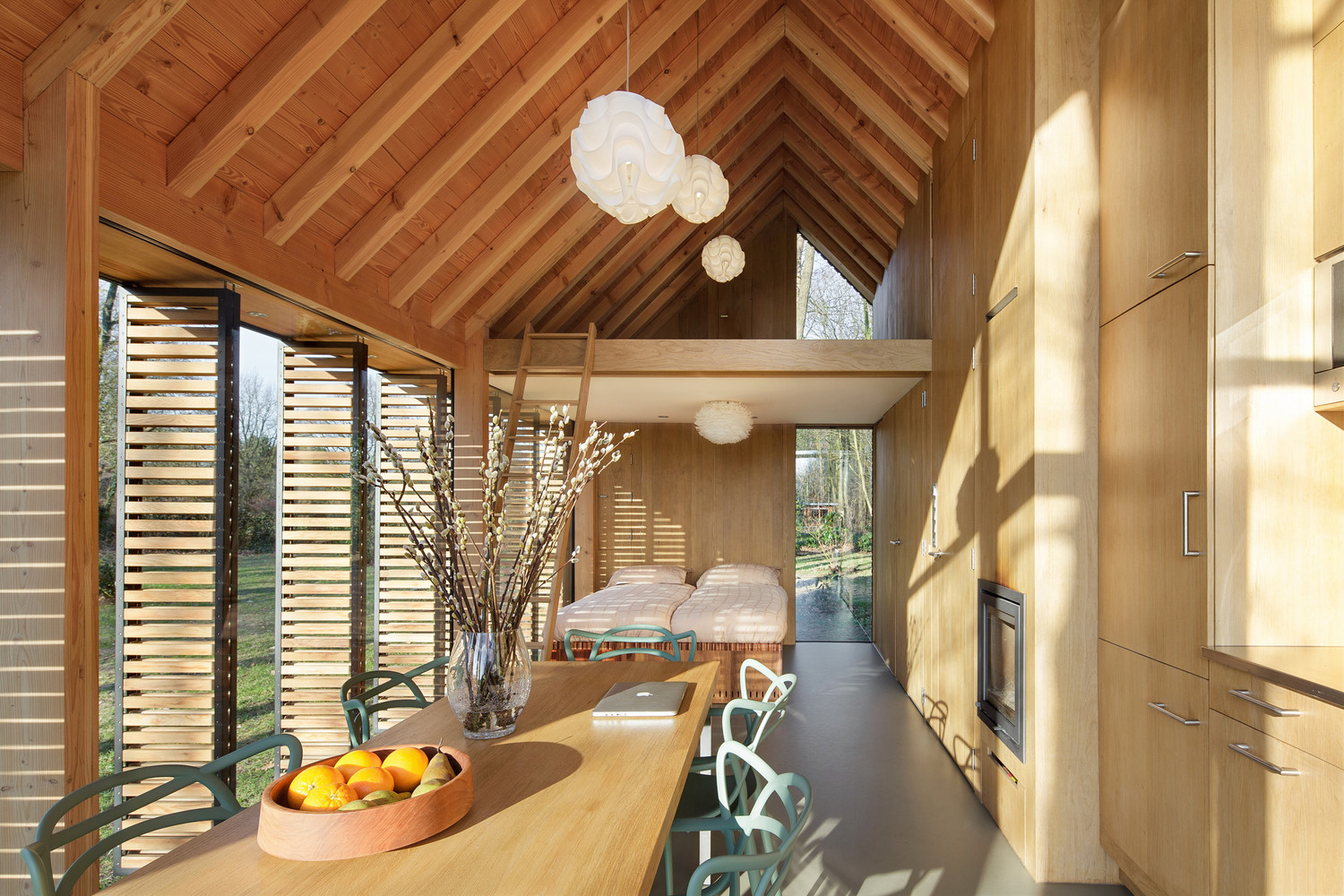 dining room with the ladder to the loft and the bedroom in the background