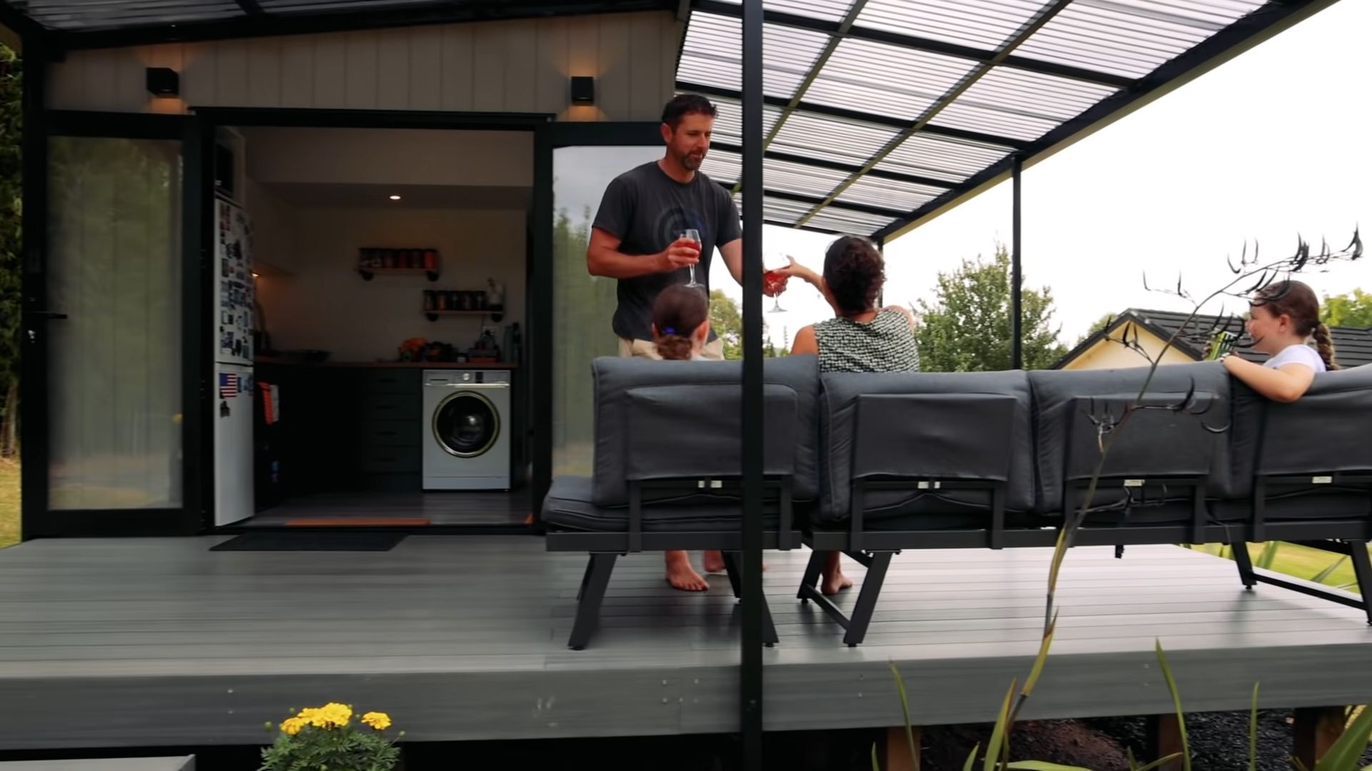 family enjoying their time sitting on the deck in front of the kitchen