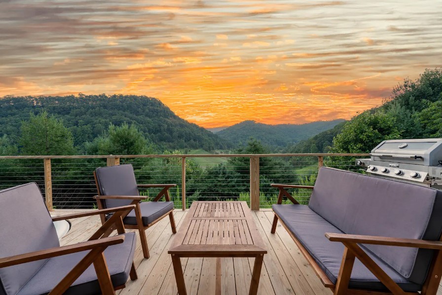 silver grill and a seating area on the deck of the living room with a beautiful view