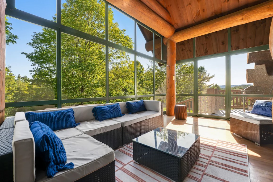 hangout area with an l-shaped couch and floor to ceiling windows