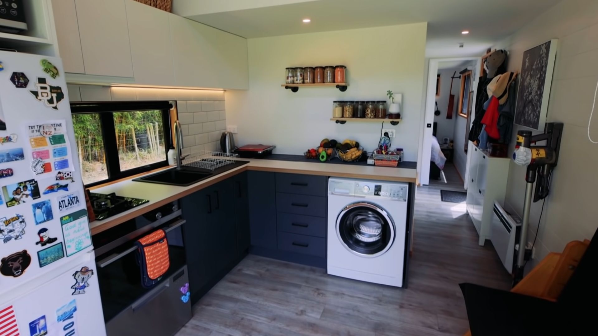 kitchen with anthracite cabinets, a washing machine, and plenty of storage space