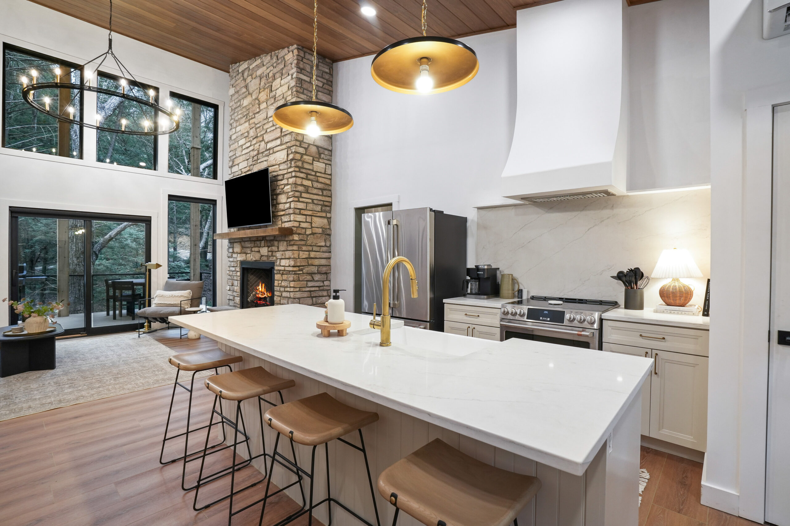 kitchen with a white countertop, four bar stools, light beige cabinets