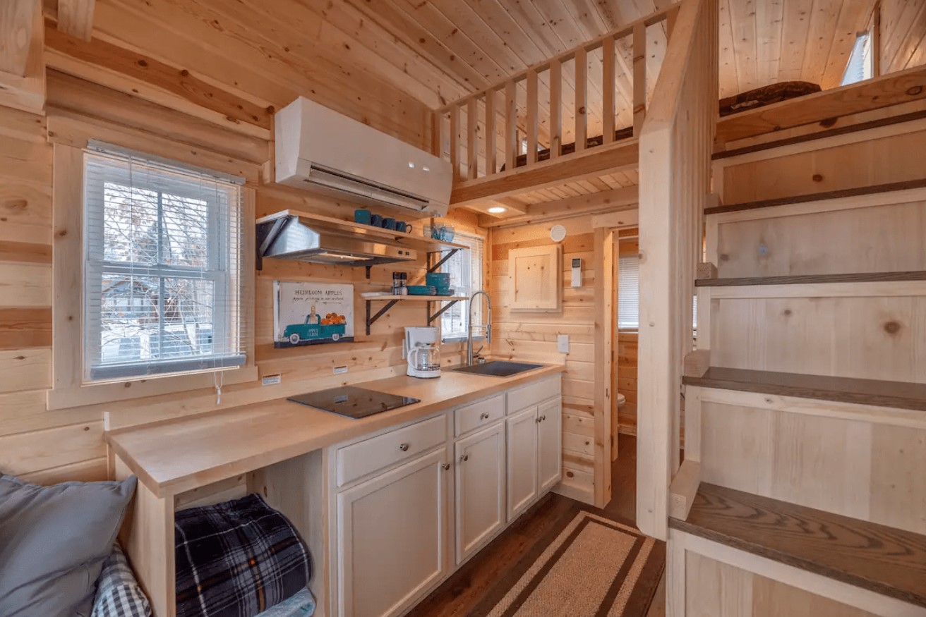 kitchen with a wooden countertop and shelves and white cabinets