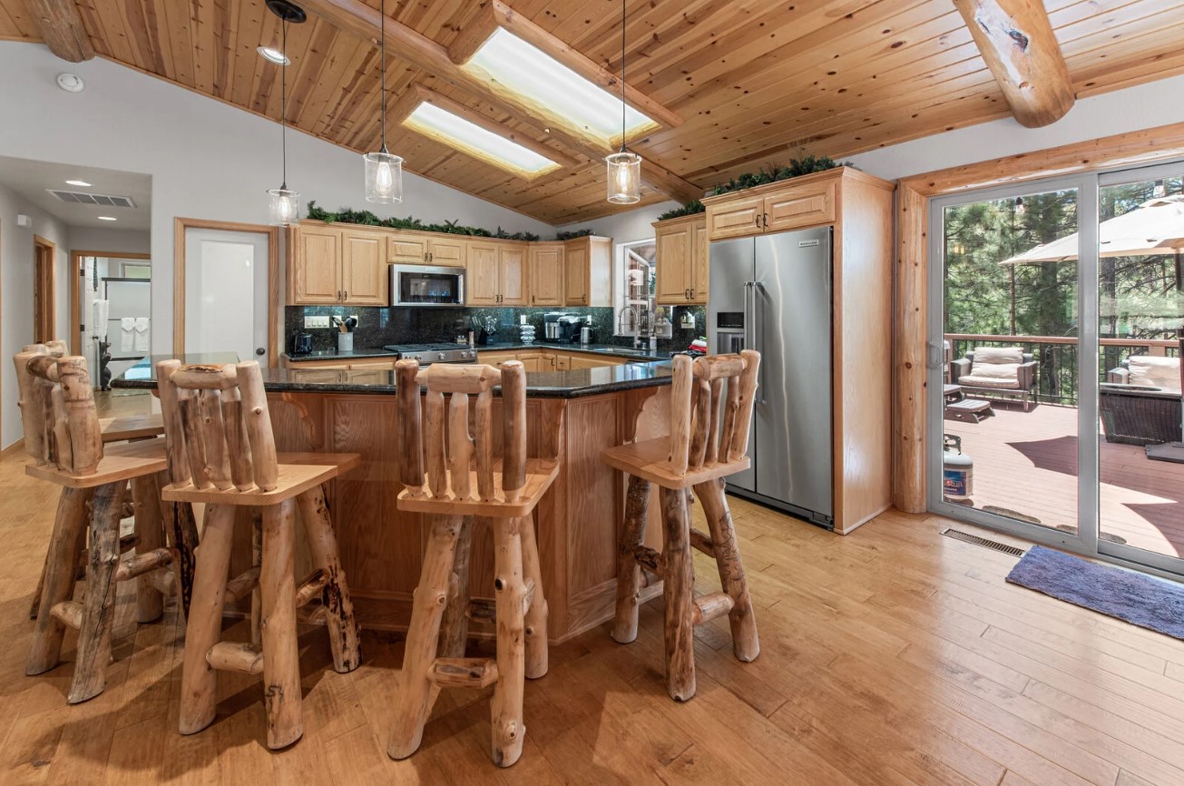 kitchen with an island and brown bar stools, brown cabinets