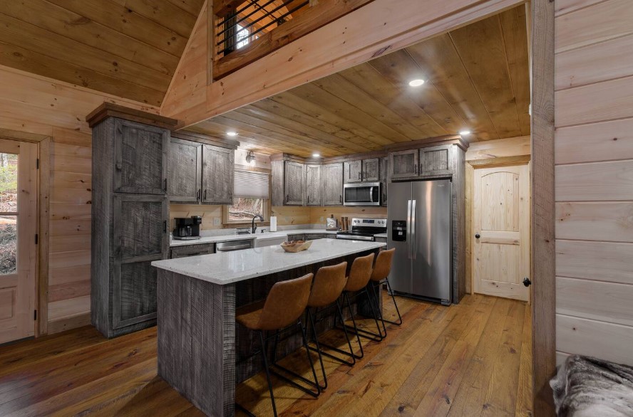 kitchen with brown-gray wooden cabinets, white countertops and four bar stools